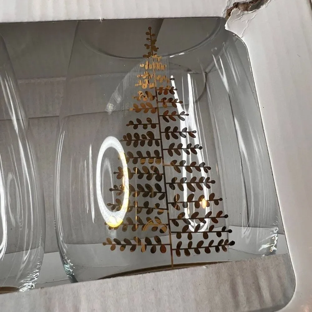 Crate & Barrel boxed set of 4 stemless wine glasses featuring a holiday tree des